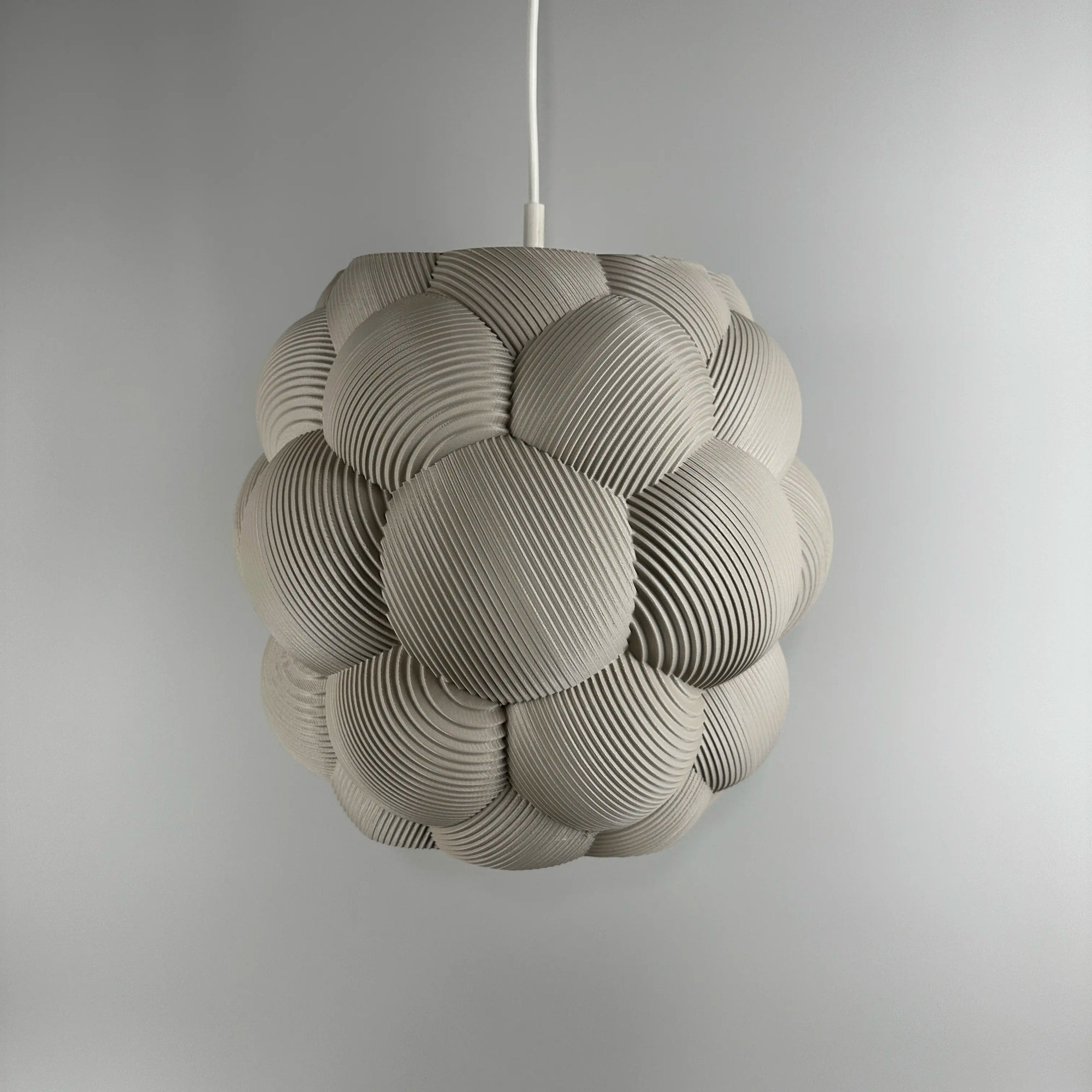 3D printed Apo Malli lampshade in modern design in muted white biodegradable material.