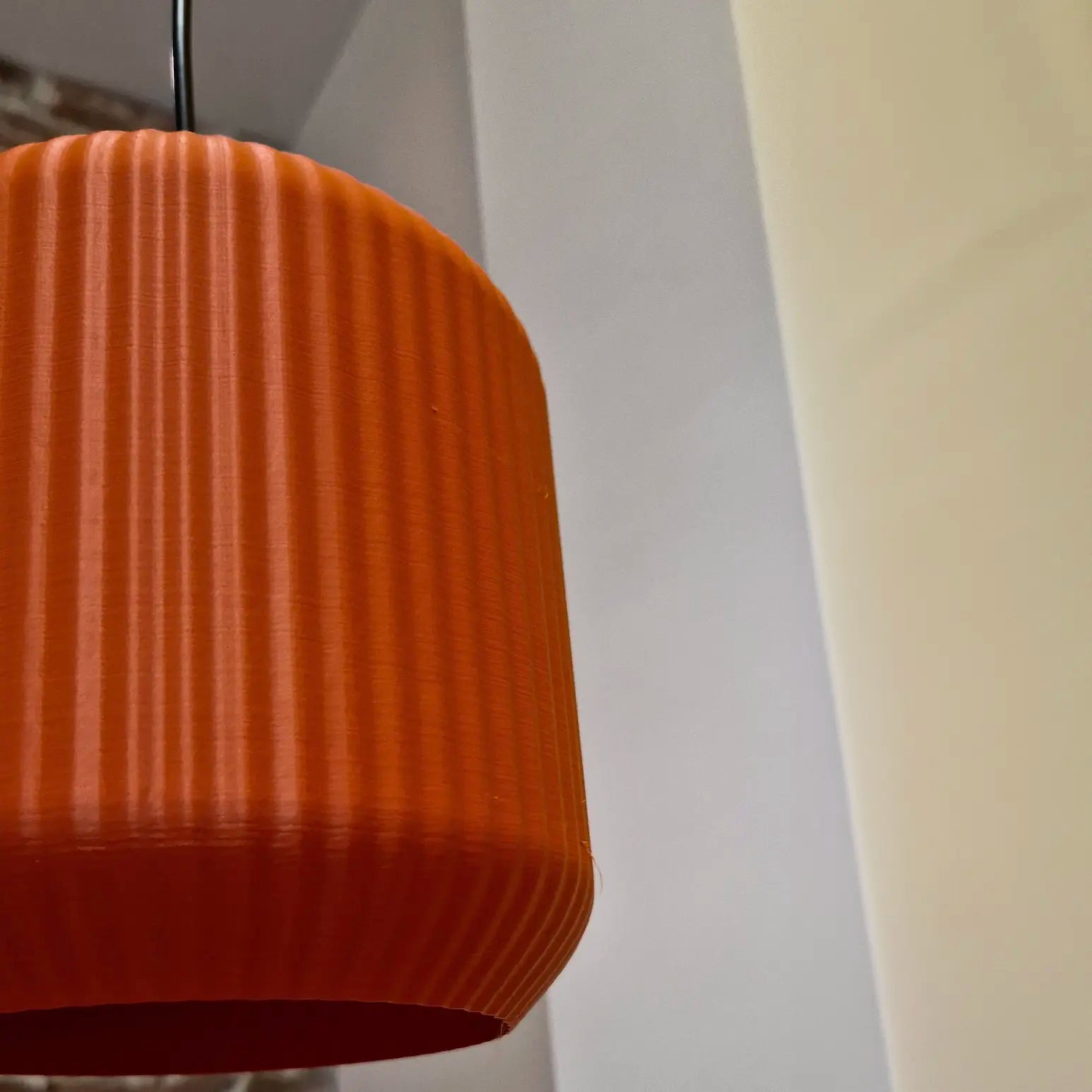 Close-up view of Lucash muted red lampshade highlighting the matte PLA filament material and detailed texture.