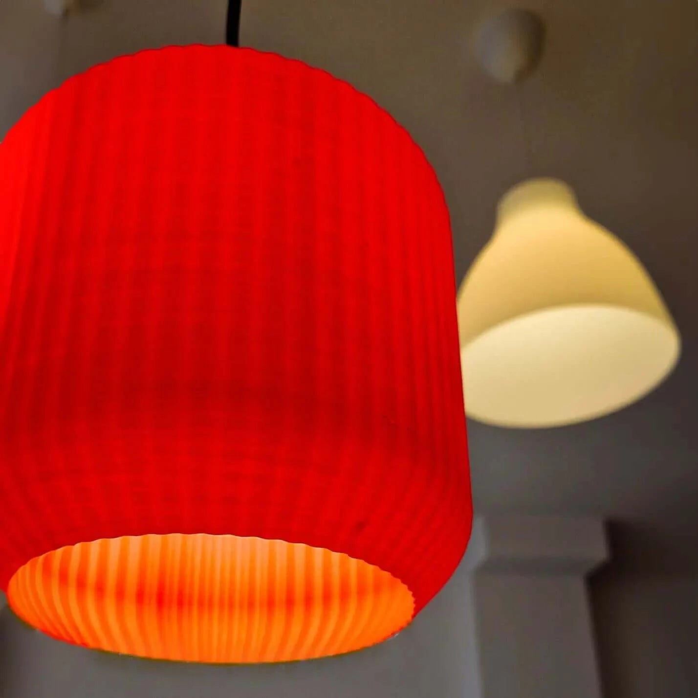 Lucash lampshade in muted red showcasing modern minimalist design and intricate 3D printed patterns.