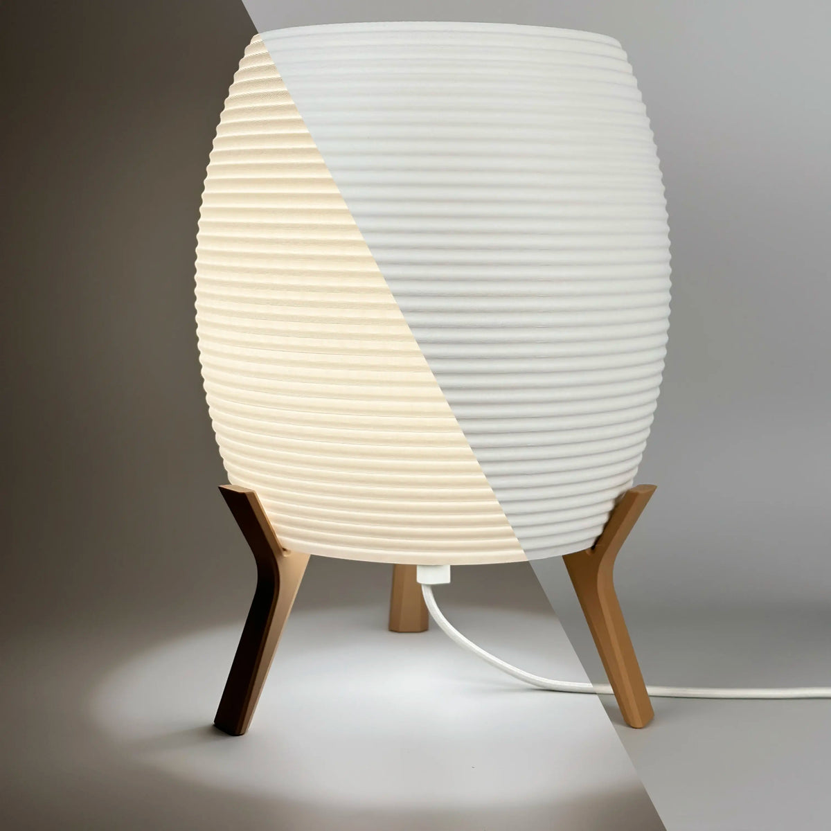 MinimalElegance Curve Table Lamp - Minimalist Bedside lamp in cotton white shade and wood brown base. Half image on and half image off.
