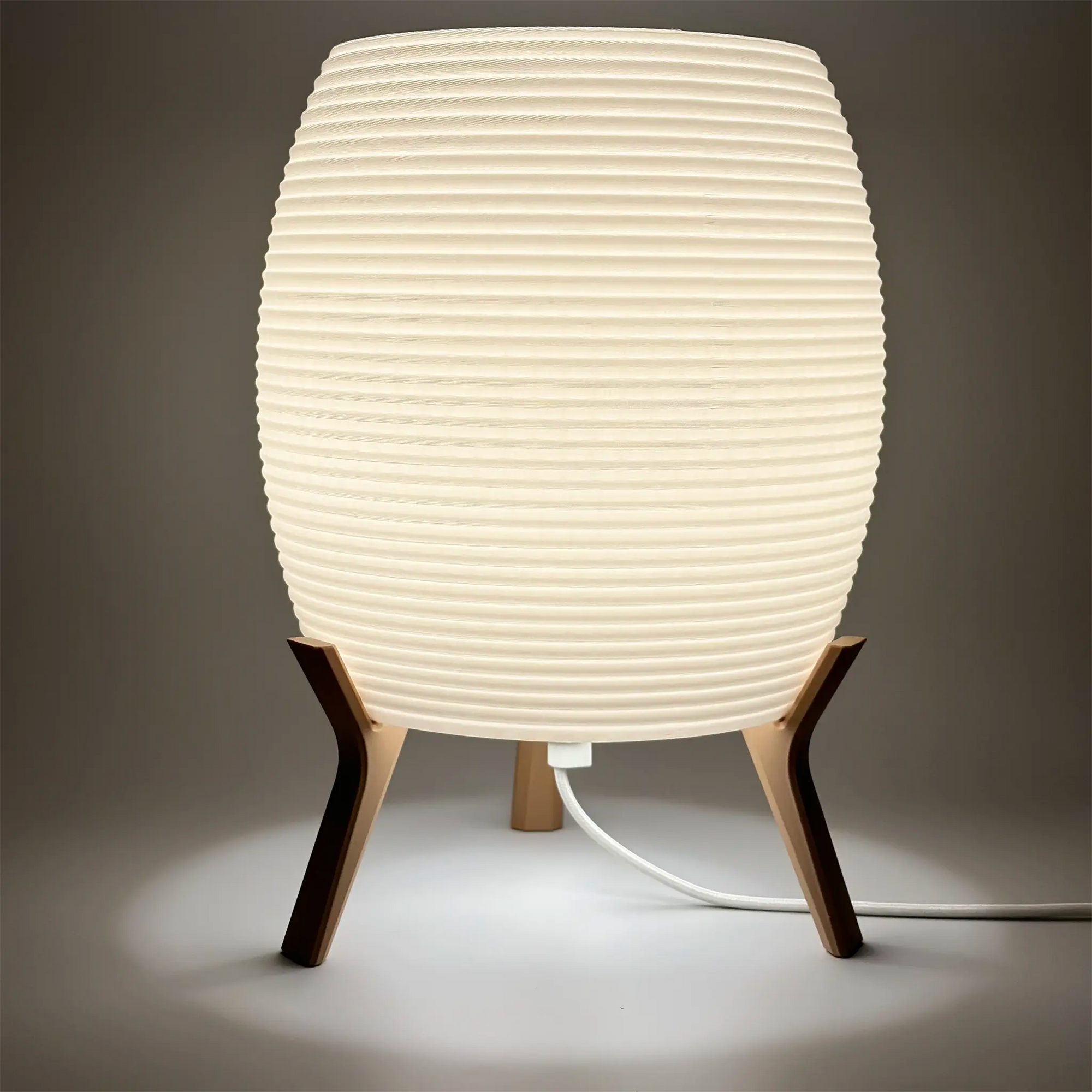 MinimalElegance Curve Table Lamp - Minimalist Bedside lamp in cotton white shade and wood brown base. Lamp is turned on with 3000k LED bulb.