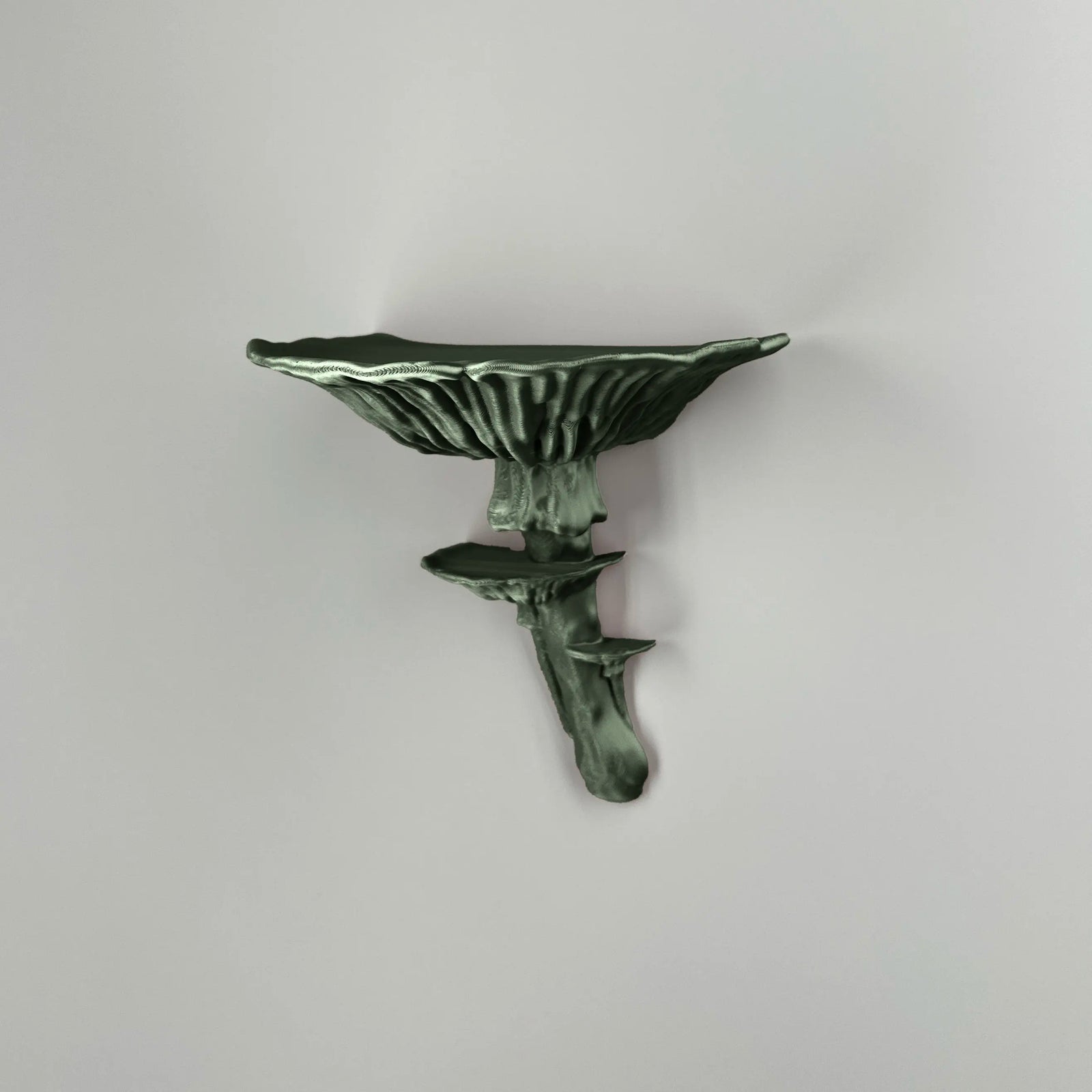 Elegant and eco-friendly Amanita Mushroom Shelf in sparkling dark green colour mounted on wall displaying small decorative items.