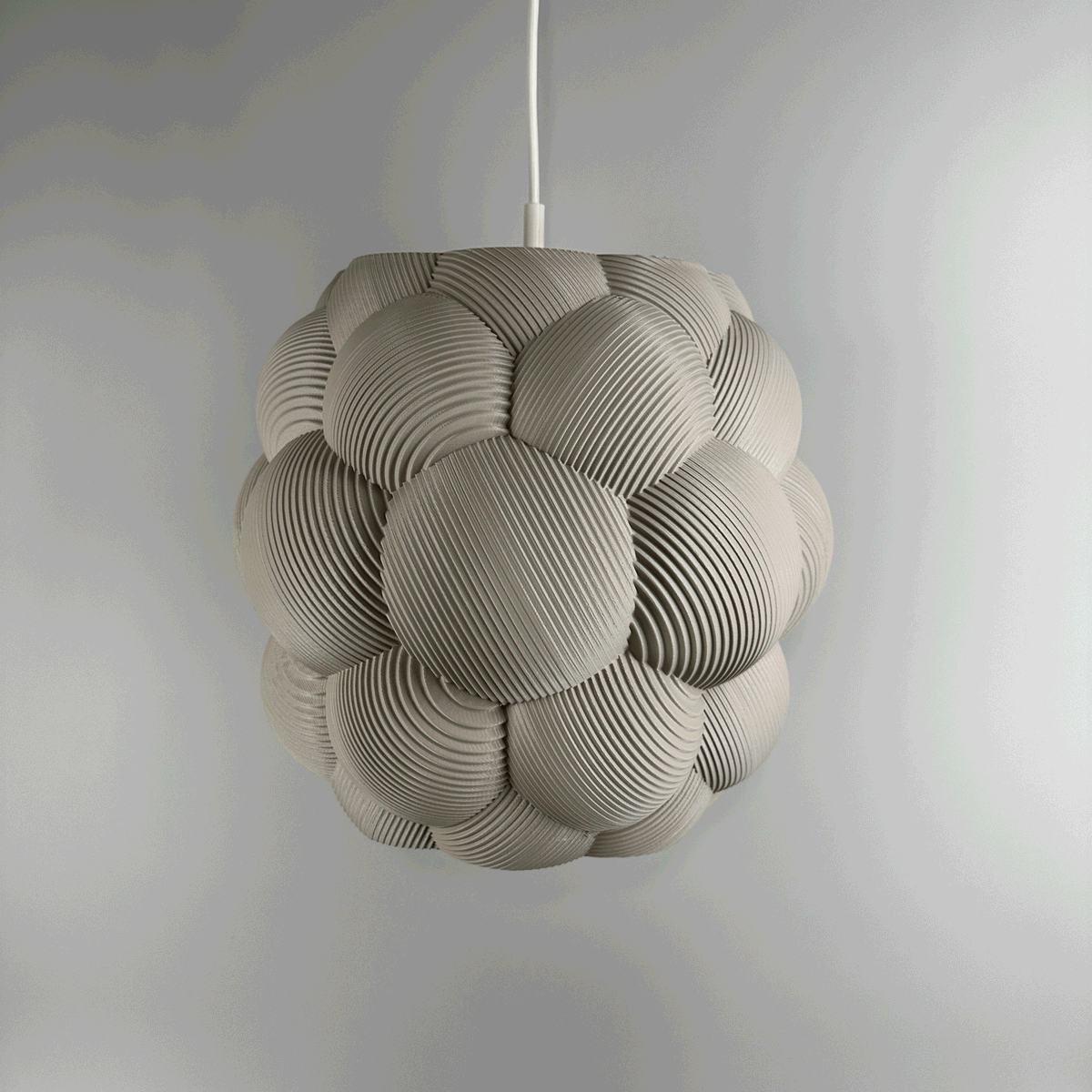 3D printed Apo Malli lampshade in modern design in muted white biodegradable material. Used with 400k LED bulb on and off